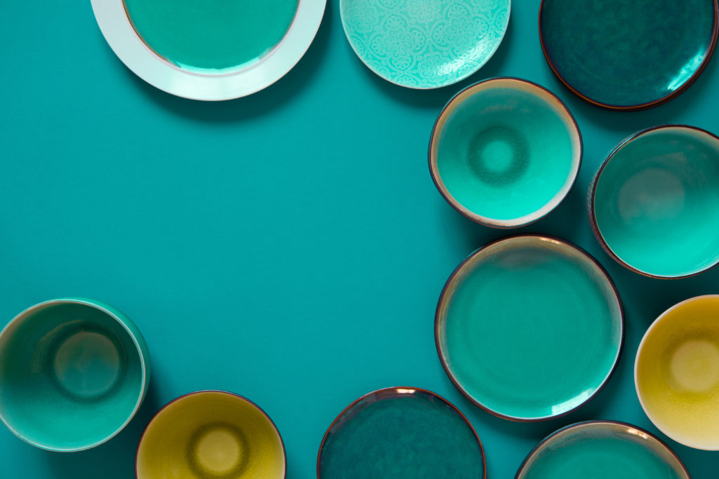 Rustic glazed plates in teal